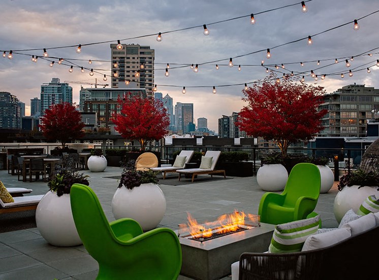 Rooftop Deck With Outdoor Seating & Fire Pit At Clarendon Apartments in Seattle, WA